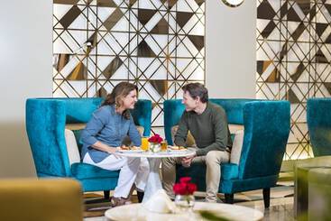 A man sat on a reclining chair with headphones in