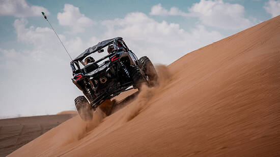 A black dune buggy dune bashing in the desert