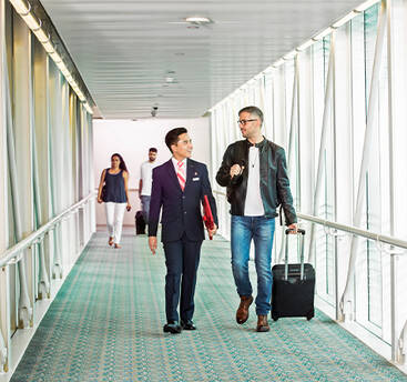 A male marhaba representative assisting a passenger