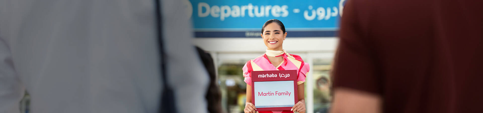 marhaba representative holding a name sign with Martin family written on it