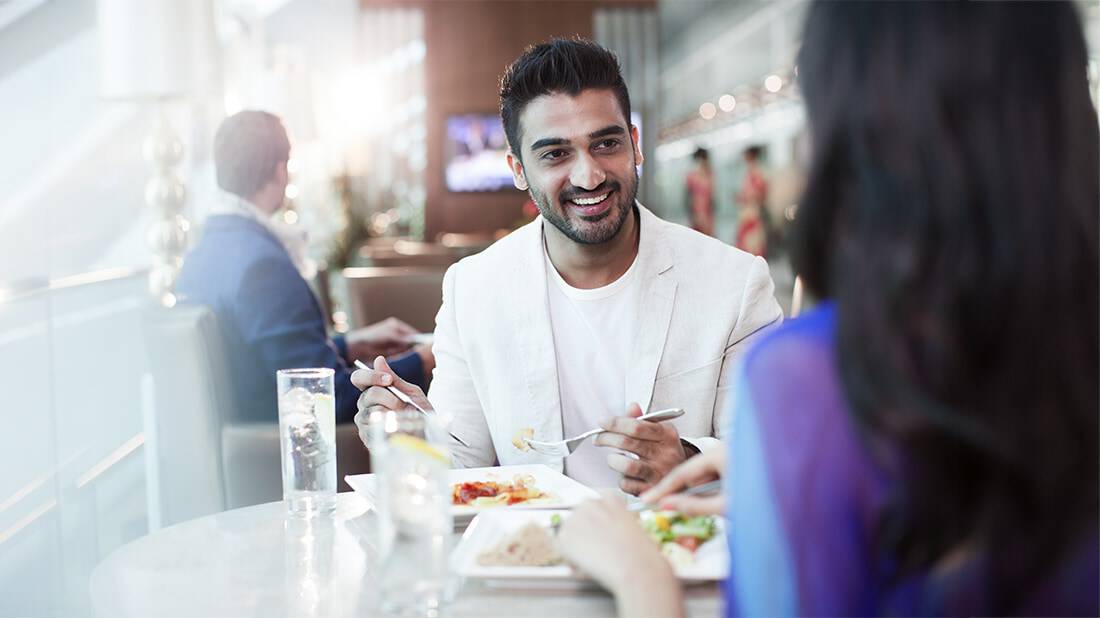 A couple eating a meal in an airport lounge