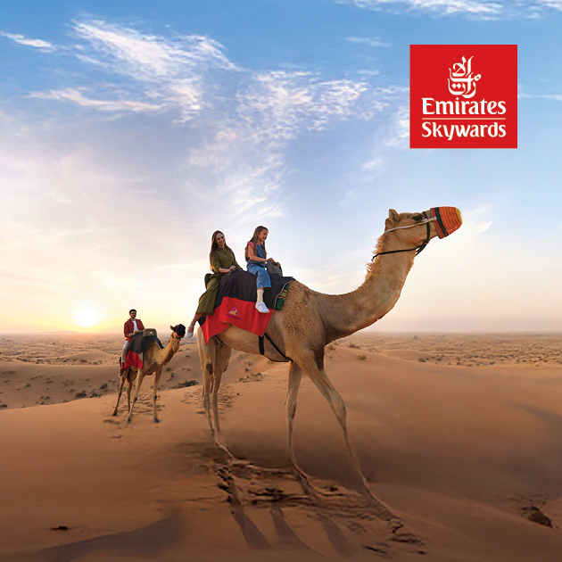 A family on a camel ride in the desert