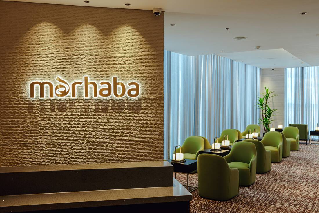 Two people sitting and having food at an airport lounge