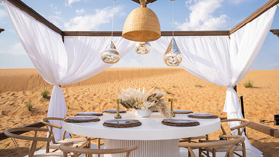 a fancy white dinner setup in the desert