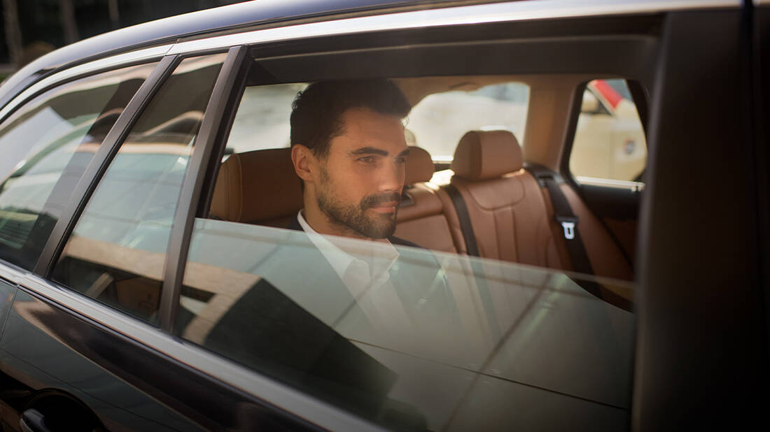 A businessman in a chauffeur-driven marhaba car