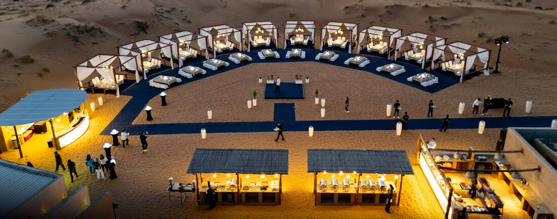 A fancy event setup in the desert at sunset