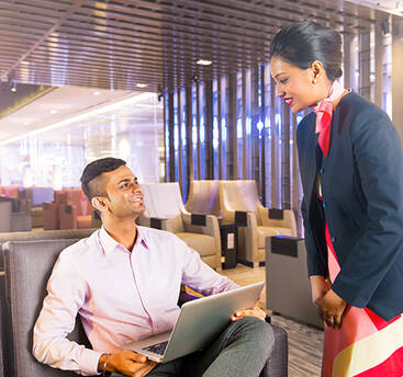 A marhaba representative assisting a seated passenger