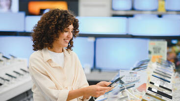 A woman shopping for a phone at a telecom store