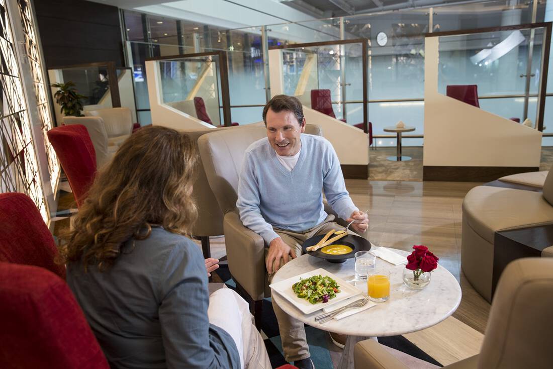 A man and woman enjoying a meal in a marhaba lounge