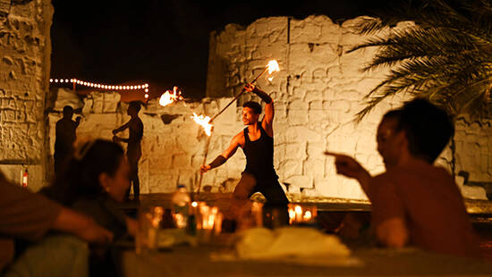a performer performing a fire show at Fort Liaisili