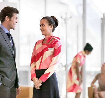 A marhaba female representative standing with a customer