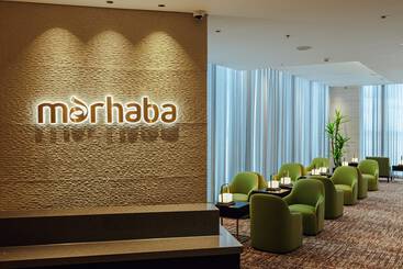 Entrance to a marhaba lounge with green arm chairs