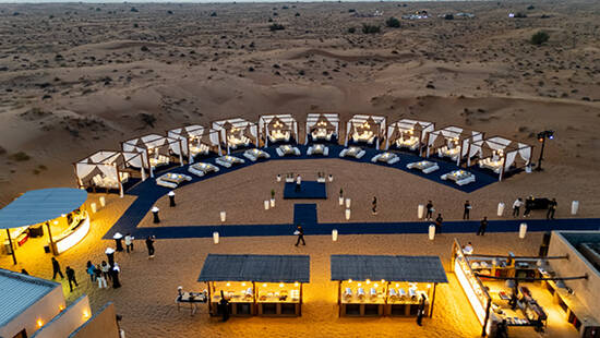 A fancy event setup in the desert at sunset