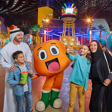A local family taking pictures with Gumball and Darwin at IMG World of Adventures