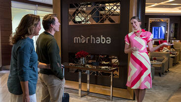 A marhaba female representative welcoming passengers into the lounge