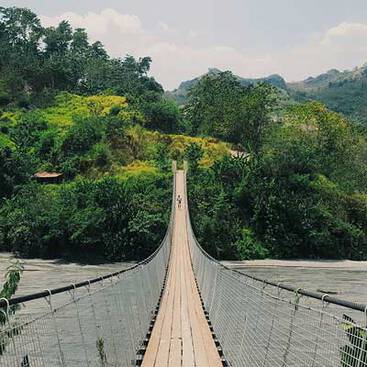 A hanging bridge in nature hanging over a river
