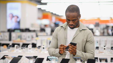 A person shopping for a phone at a telecom store