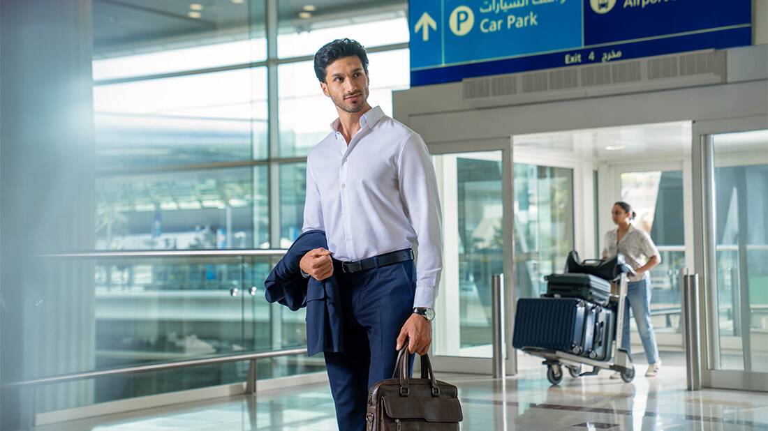 A businessman walking through the airport with a briefcase