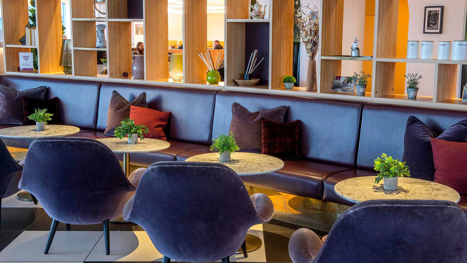 Blue seating area at Plaza Premium Lounge London Gatwick Airport