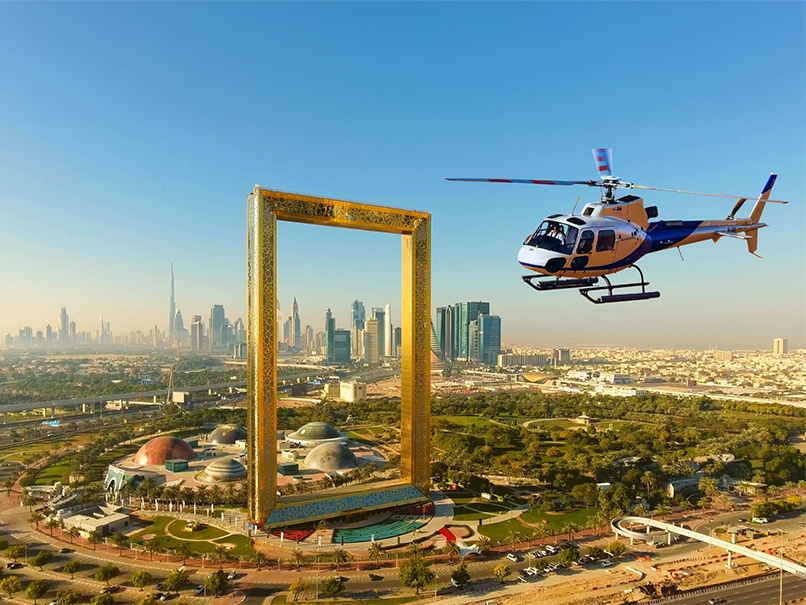 Desert safari A photograph of a helicopter flying past the Dubai Frame